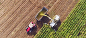 An arial view of a tractor harvesting crops